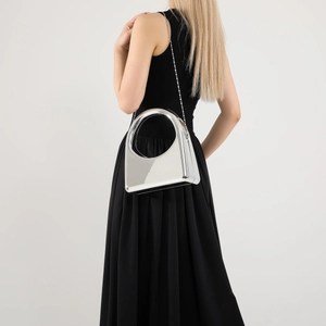 Side view of silver metallic geometric evening bag with stylish metal chain strap
