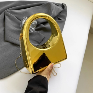 Detailed macro view of the gold mirror acrylic evening bag with unique round handle