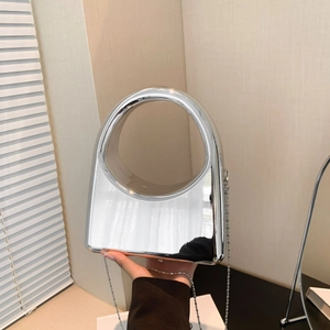 Close-up of a silver acrylic evening bag with mirror finish and stylish circular handle