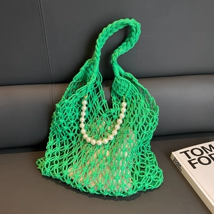 Vibrant green woven mesh beach bag with pearl handle and inner drawstring pouch