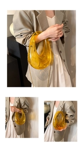 Detail of yellow transparent acrylic geometric clutch bag with gold chain strap