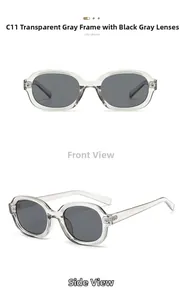 Detail view of oval grey sunglasses with transparent frames and dark lenses