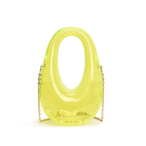 Detail of neon green transparent acrylic evening clutch with gold chain strap