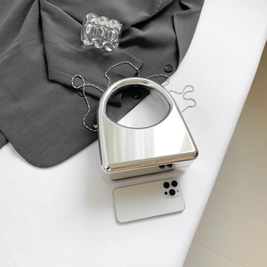 Minimalist silver mirror evening clutch bag with circular handle and metal chain strap