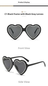Macro view of heart-shaped black sunglasses with sparkling white rhinestones inlays