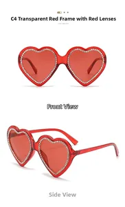 Close-up of heart-shaped sunglasses with red transparent frames and sparkling rhinestones