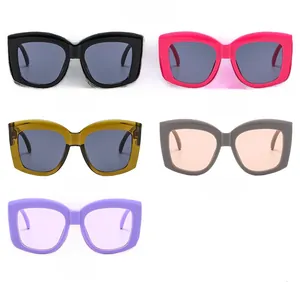 Flat lay of five chunky square sunglasses in assorted vintage colors from black to purple