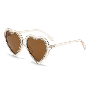 Fashionable heart-shaped sunglasses with champagne frame and sparkling rhinestones