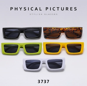 Detailed view of chunky Y2K sunglasses in black, tortoiseshell, green, yellow, and white