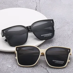 Detail view of large frame polarized sunglasses in classic black and chic beige colors
