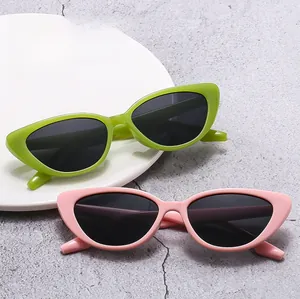 Detail showing retro cat-eye sunglasses in green and pink frames with black lenses