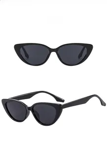 Detail view of cat eye sunglasses with thick black frames and dark gray tinted lenses