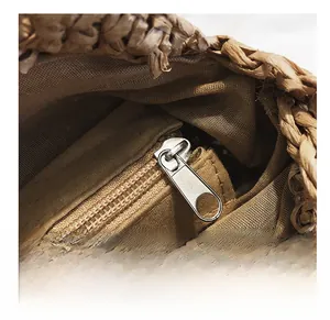 Detail show of straw woven beach bag featuring internal zipper pocket and durable lining