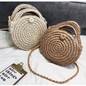 Detail of hand-woven straw bags showing circular spiral textures and beige brown tones