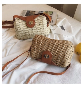 Handmade woven straw crossbody bag with leather flap and metal turn-lock closure