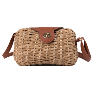 Handwoven straw crossbody bag with brown leather flap and golden twist lock closure