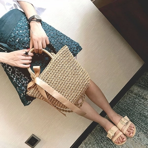 Handwoven beige straw bag with champagne satin bow and matching flat sandals for beach