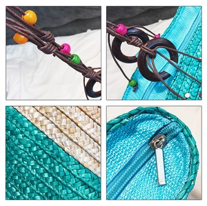 Detail of straw woven beach bag featuring colorful wooden beads and a blue zipper closure