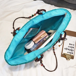 Blue straw beach tote bag with wooden handles and large capacity for summer vacation