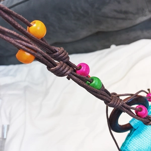 Handmade straw beach bag with bohemian beaded straps and contrast color starfish design