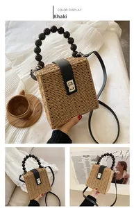 Khaki woven straw bag featuring acrylic bead handle and crossbody strap for beach vacation