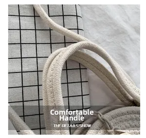 Detail of the thick woven handle on a light beige straw bag with soft shadow texture
