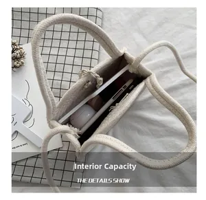Internal capacity of the off-white woven bag showing space for phone and power bank