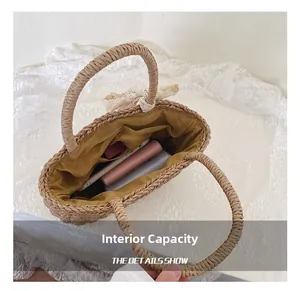 Internal capacity of straw woven tote bag showing lining, inner pocket and lace bow