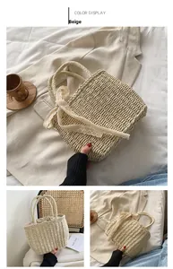 Detail of beige straw handbag with delicate white lace ribbon for beach vacation styling