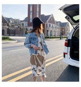 Straw tote bag with white lace ribbon detail worn with denim jacket and floral dress
