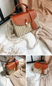 Detail of brown straw handbag with leather flap, gold twist lock and rope strap