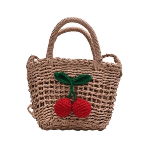 Handmade straw tote bag with crochet cherry charms for summer beach vacations