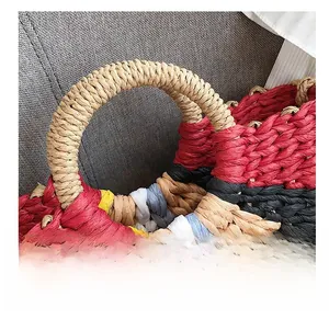 Detail of colorful woven paper rope handbag with circular handles and striped texture