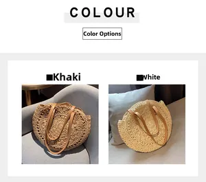 Detail view of round woven straw beach bags in khaki and white with faux leather handles