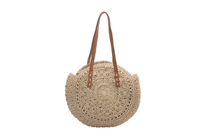 Close-up of circular straw beach bag featuring woven textures and premium PU leather handles