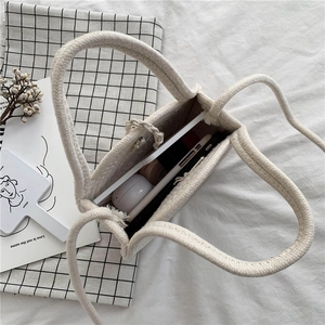Minimalist hand-woven cotton rope tote bag with visible interior storage and soft textures