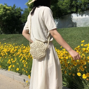 Detailed close-up of a cream handmade hollow star-shaped woven bag with floral texture
