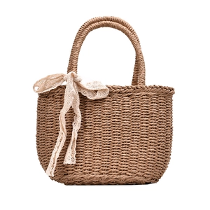 Natural straw tote bag with lace ribbon decor for summer beach holidays and vacations