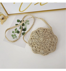 Detailed close-up of handmade round woven petal crossbody bag in natural beige fiber