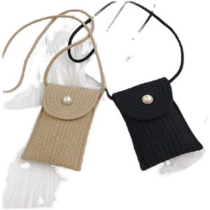 Detail view of woven cotton phone bags with pearl buttons in khaki and black colors