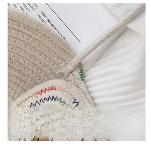 Detail of colorful woven stitching and strap attachment on the cotton rope bag