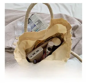 Top-down view of a straw tote bag showing large capacity with personal essentials