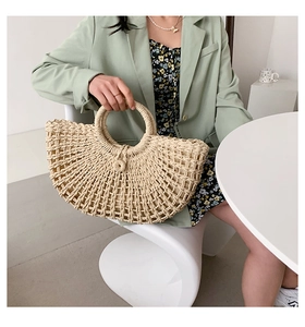 Bohemian crescent straw bag styled with mint blazer in a cozy lifestyle setting