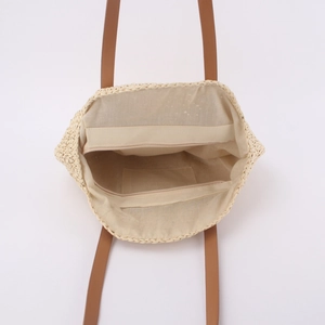 Handmade straw tote bag with brown leather handles and zipper closure for summer beach vacation