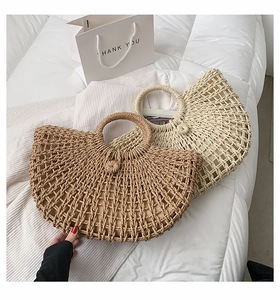 Detail of hollow woven straw tote bags in beige and brown for summer beach vacations