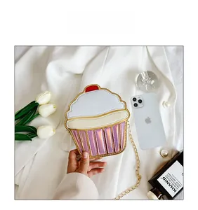 Detail view of cupcake shaped crossbody bag with iridescent pink stripes and chain