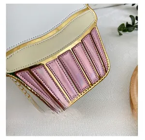 Close-up of precise stitching on creative cupcake-shaped bag with gold chain strap