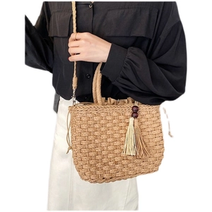 Retro handmade straw woven handbag with drawstring closure and tassel charm for women
