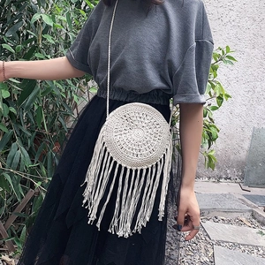 Bohemian off-white round woven cotton bag with long tassels for summer beach wear