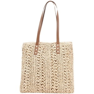 Handmade woven straw tote bag with brown leather handles for summer beach style